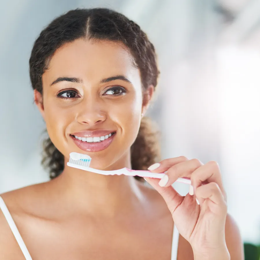 Woman brushing teeth with proper technique