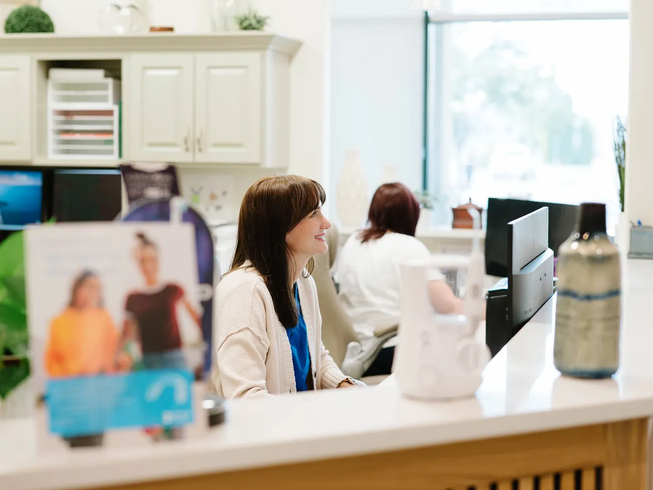Front desk team member greeting a patient at CrossPointe Dental