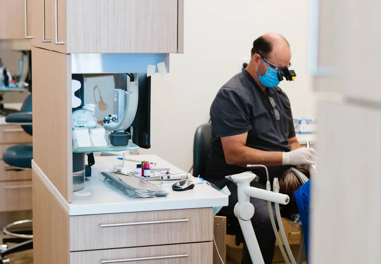Dentist using modern chairside technology to treat a patient at CrossPointe Dental